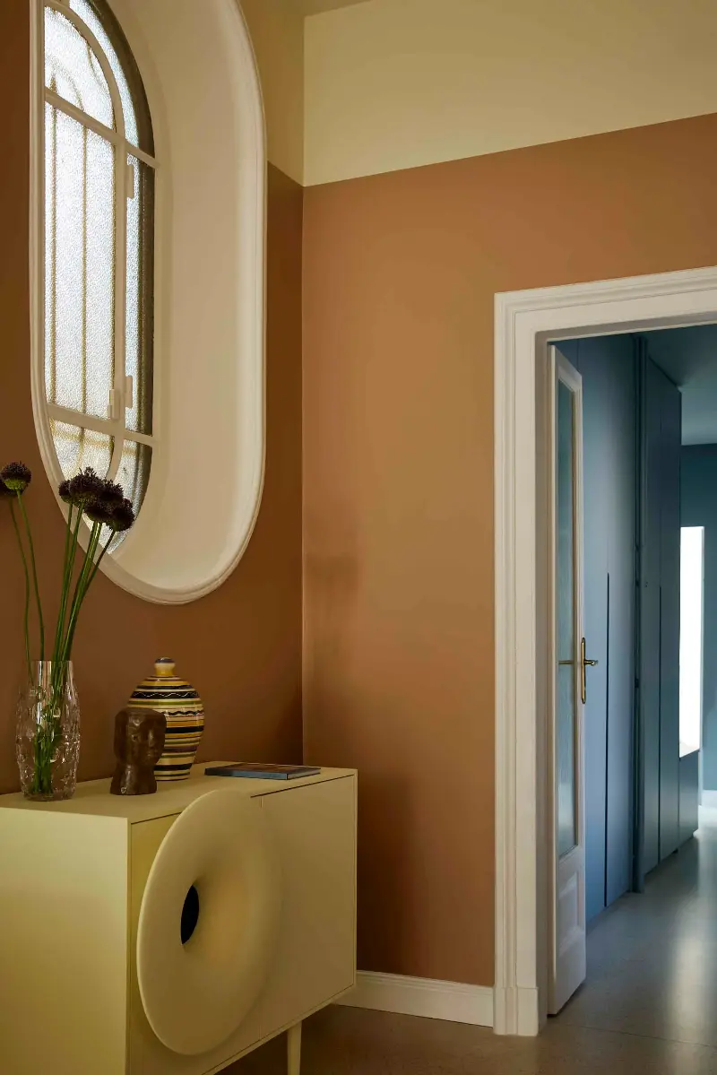 Adding in other shades in similar tones, like this pale yellow console, invites a more nuanced palette. (Image credit: Atelier Zero)