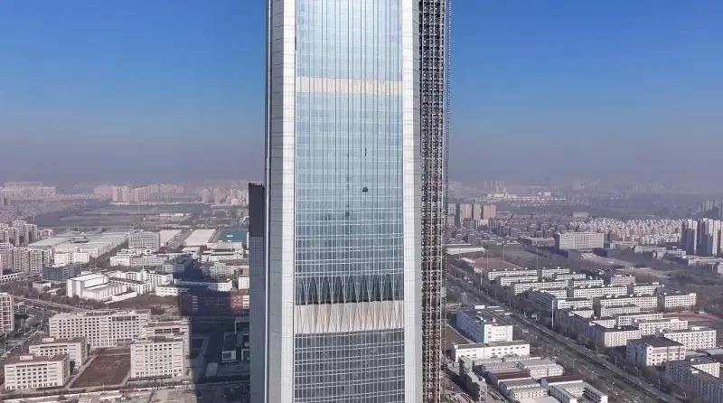 A close-up view of the facade of the Goldin Finance 117 tower in its current construction phase.