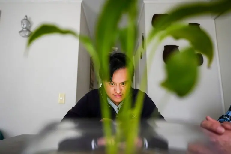 Actor Sebastián Solorza, who has Down syndrome and aims to run for president as an independent candidate, relaxes in his home in Santiago, Chile, Thursday, July 31, 2025. (AP Photo/Esteban Felix)