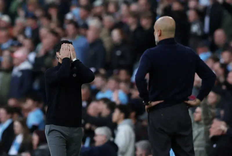 Mikel Arteta (left) and Pep Guardiola, managers at Arsenal and Manchesyer City respectively, during their Premier League match on Sunday. 