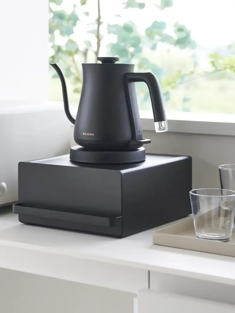 A black extendable kitchen storage shelf from Yamazaki