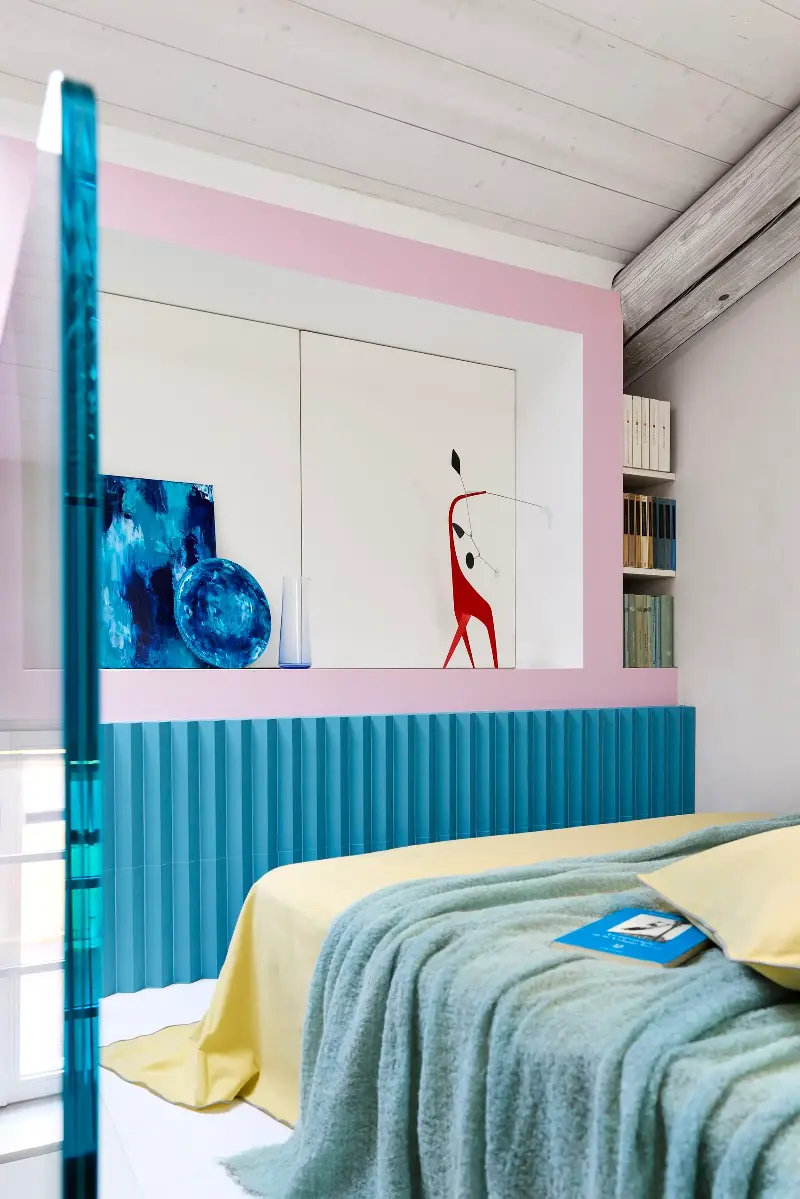 Although the bedroom feels sans-surreally serene, it's cohesively unbereft of color.Thomas Pagani. Design: Studio Paradisiartificiali with Owen Gent. Styling: Giulia Taglialatela