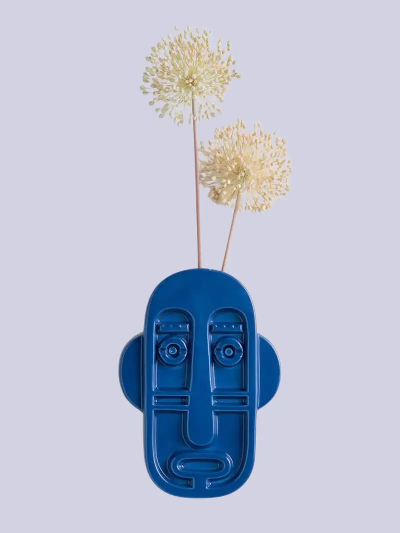 A blue face-shaped decorative wall vase from The Masie