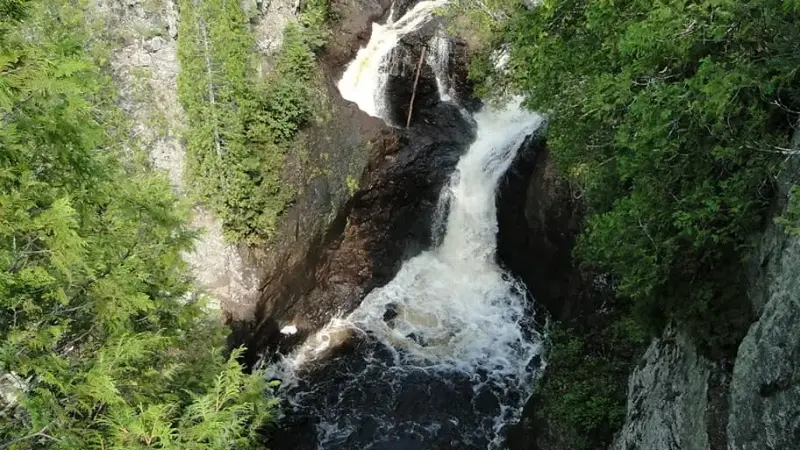 Water flows into the Devil's Kettle (top waterfall) and seemingly doesn’t come out.