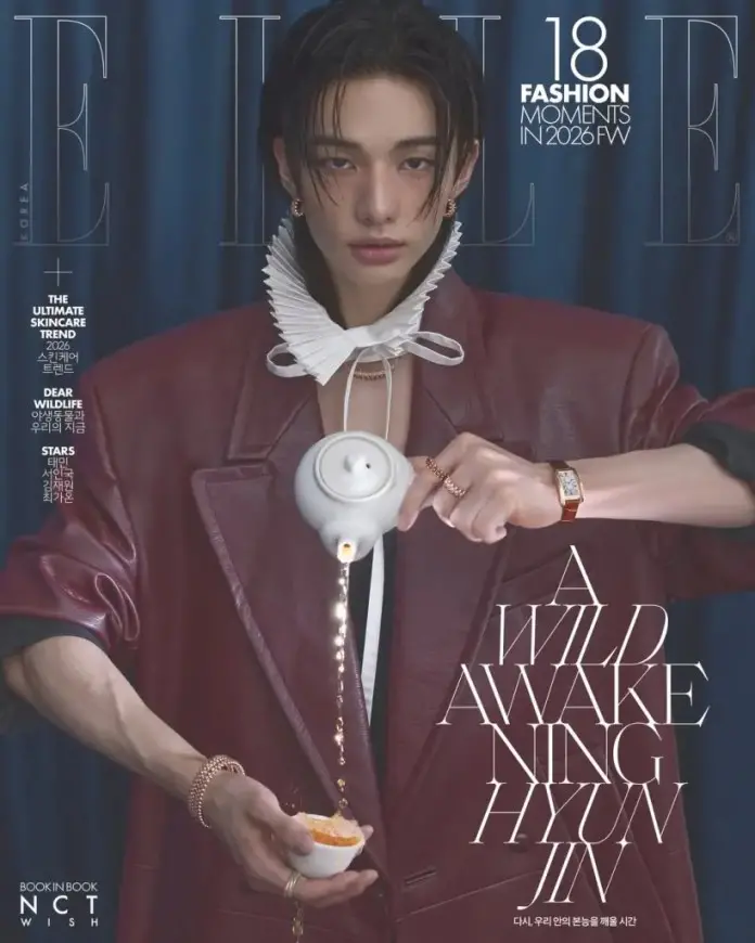 Magazine cover featuring Hyunjin with long hair in a stylish outfit, pouring tea from a teapot into a small cup, surrounded by elegant styling and text.
