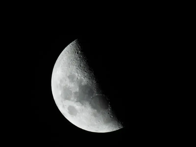 Close-up of the moon in black and white, showcasing its craters and texture.