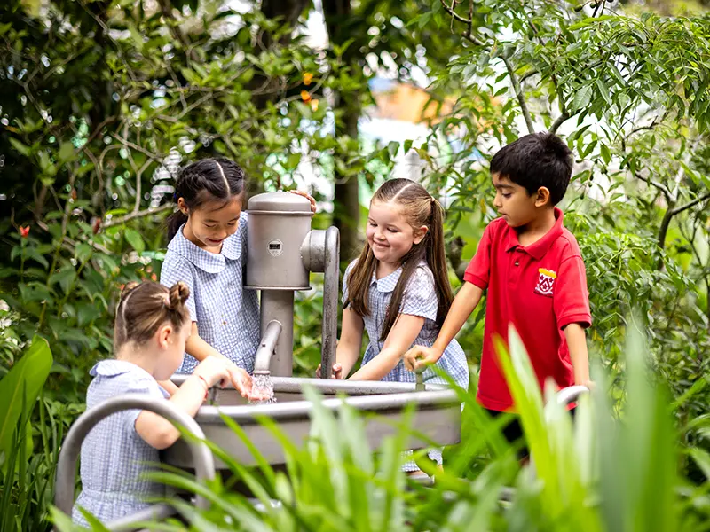 students of Dulwich DUCKS Singapore in water play outdoors 