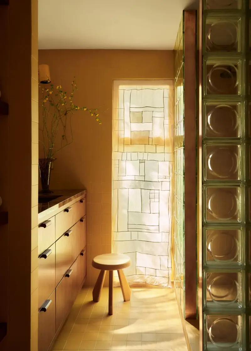 Paired with wood tones and glass, ochre takes on a modern feel in this bathroom. (Image credit: Patrick Biller. Design: Ome Dezin)