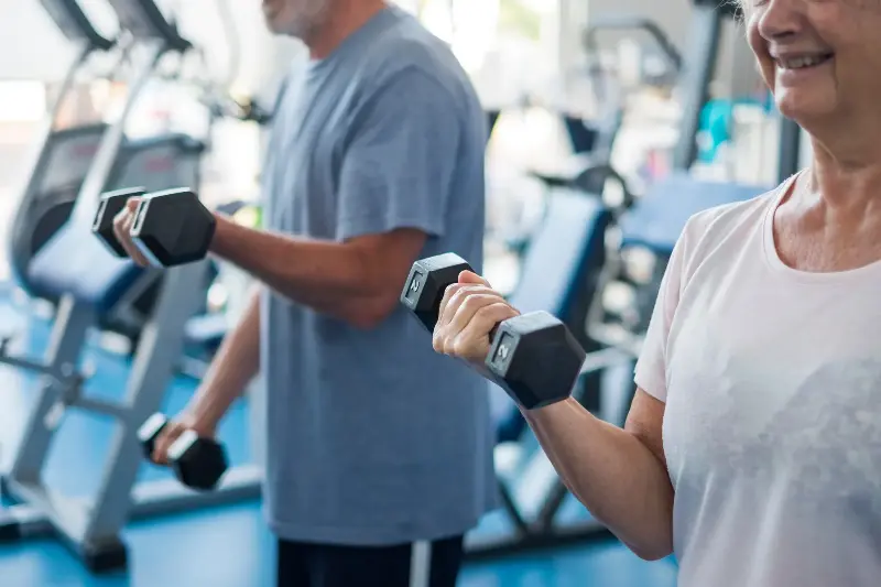 Undated stock image of two senior people at the gym doing exercise.