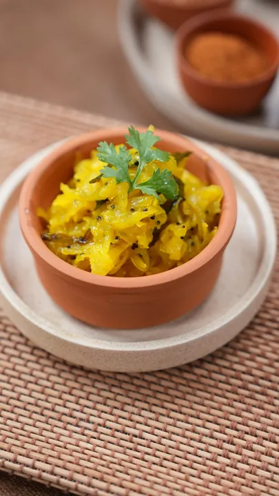 Sanjeev Kapoor’s papaya sambharo showcases raw papaya combined with mustard seeds, green chillies, and curry leaves.