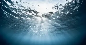 Earth’s largest waterfall is hidden underwater in the Denmark Strait between Iceland and Greenland, where dense cold water plunges about 3,500 meters down the seafloor, far exceeding any waterfall on land in drop height and volume