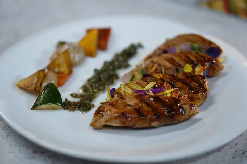 Enjoy a wholesome meal with Sanjeev Kapoor's grilled chicken and veggies accompanied by a fresh salsa verde.