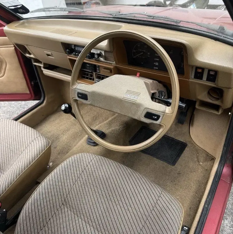 The tiny Alto features an AM/FM radio, front head restraints, a cigarette lighter, and two-speed wipers with electric washers