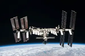 The International Space Station is not held up by rockets. It is falling constantly, in a precise arc that matches the curvature of Earth — a controlled fall that has continued without interruption since November 2000
