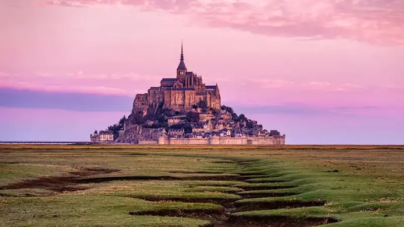 Mont Saint-Michel at sunrise in Normandy, France.