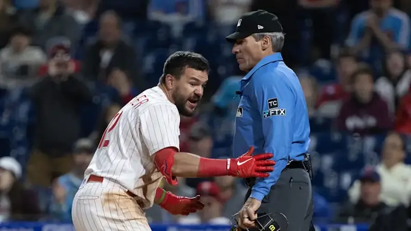 Philadelphia Phillies designated hitter Kyle Schwarber (12) argues with umpire Angel Hernandez