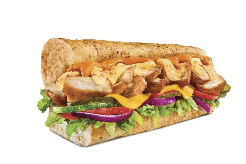 Subway's Rotisserie Style Chicken sub with lettuce, tomato, cucumber, red onion and sauce on a seeded sub roll