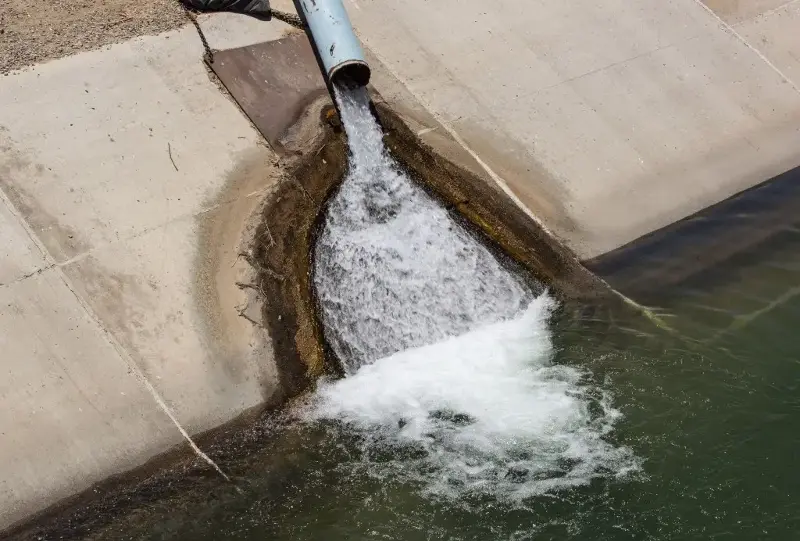 Pumped groundwater flows into the California State Aqueduct at the junction of Highway 166 in July 2021, near Wheeler Ridge, California.
