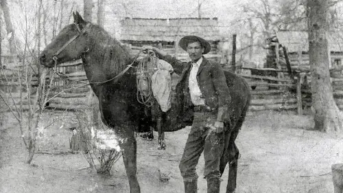 A cowboy and his horse, circa the 1880s.