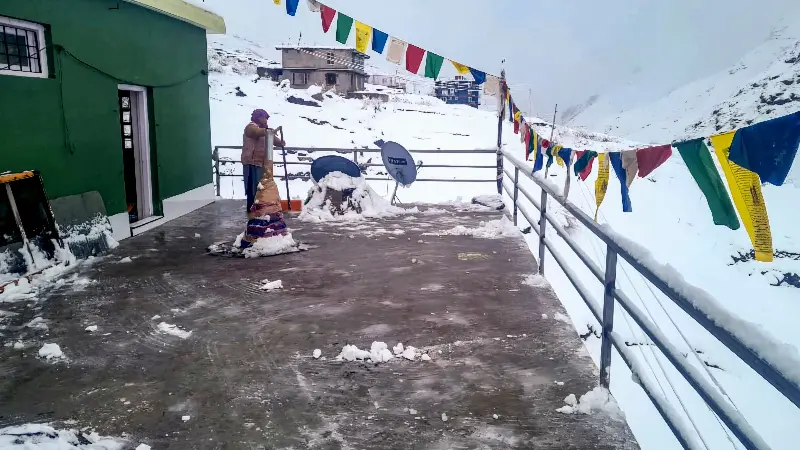 A resident clears snow following fresh snowfall, in Sissu, Lahaul and Spiti district, Himachal Pradesh, Saturday, April 4, 2026. 