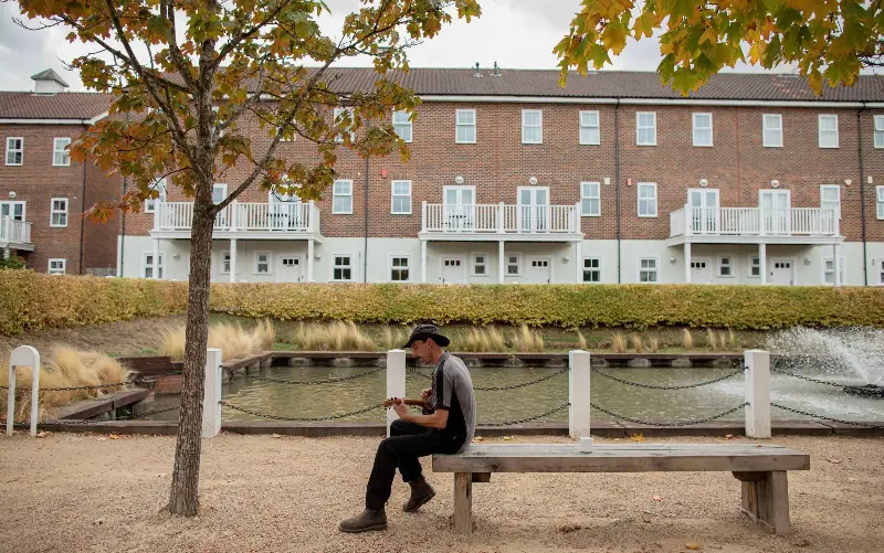 John Brown, the head gardener at the Hamptons for ten years, plays his ukele in the grounds - SWNS/William Lailey