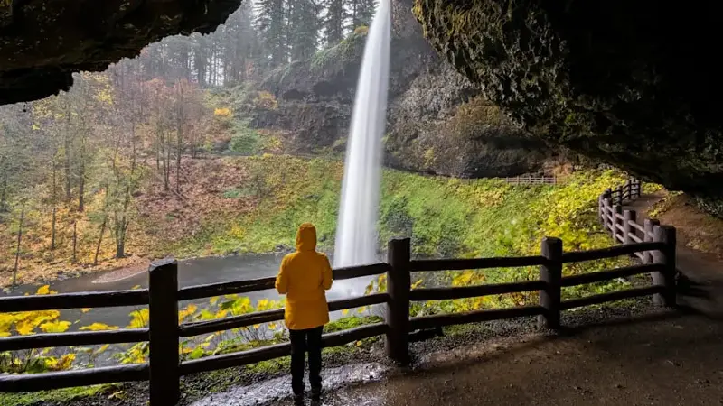 Woman visiting South Falls, Silver Falls State Park, Oregon, US.