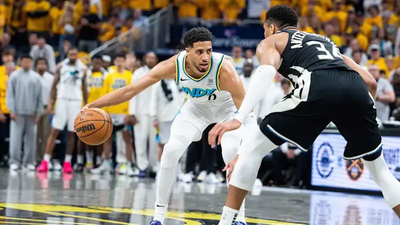  Indiana Pacers guard Tyrese Haliburton dribbles the ball while Milwaukee Bucks forward Giannis Antetokounmpo defends 