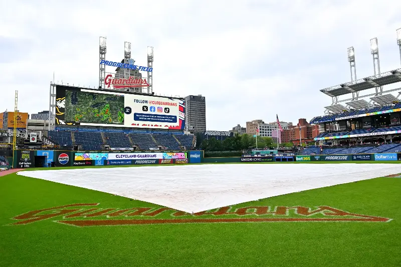 The tarp sits on the infield of Progressive Field during a rain delay before the game between the Cleveland Guardians and the San Diego Padres on August 16, 2026 in Cleveland, Ohio. (Photo by Jason Miller/Getty Images)