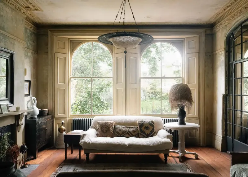 Beautiful arched windows flood the living room with natural light.  (Image credit: Fabco, Studio Sam Causer)
