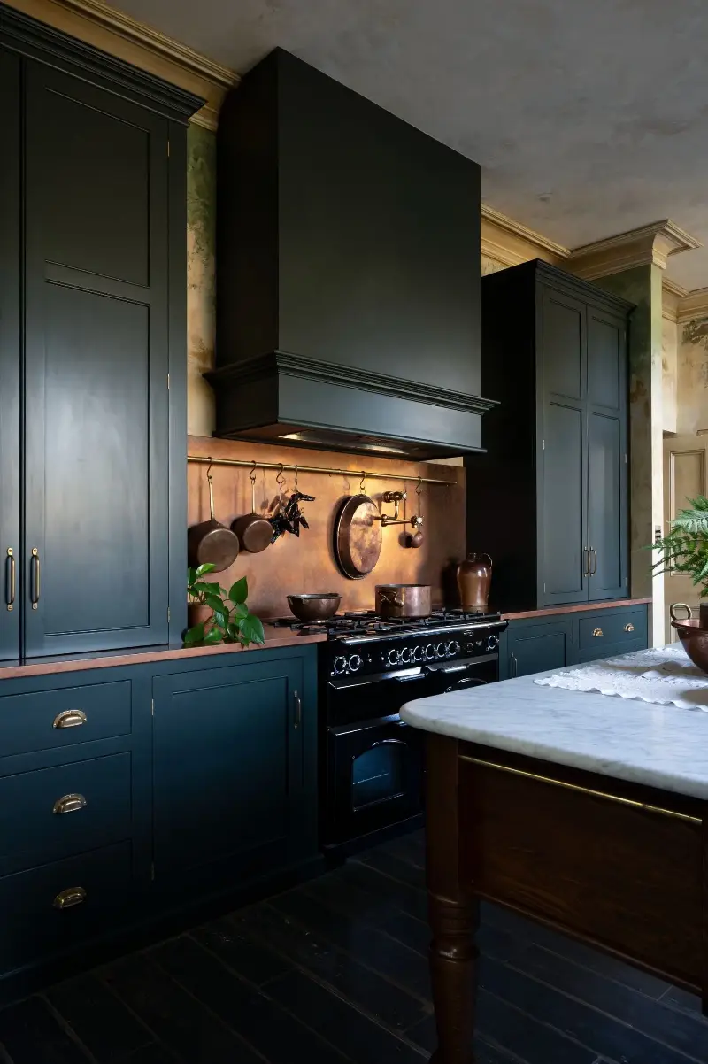 The rich patina of the copper backsplash adds more warmth to the kitchen. (Image credit: deVOL)