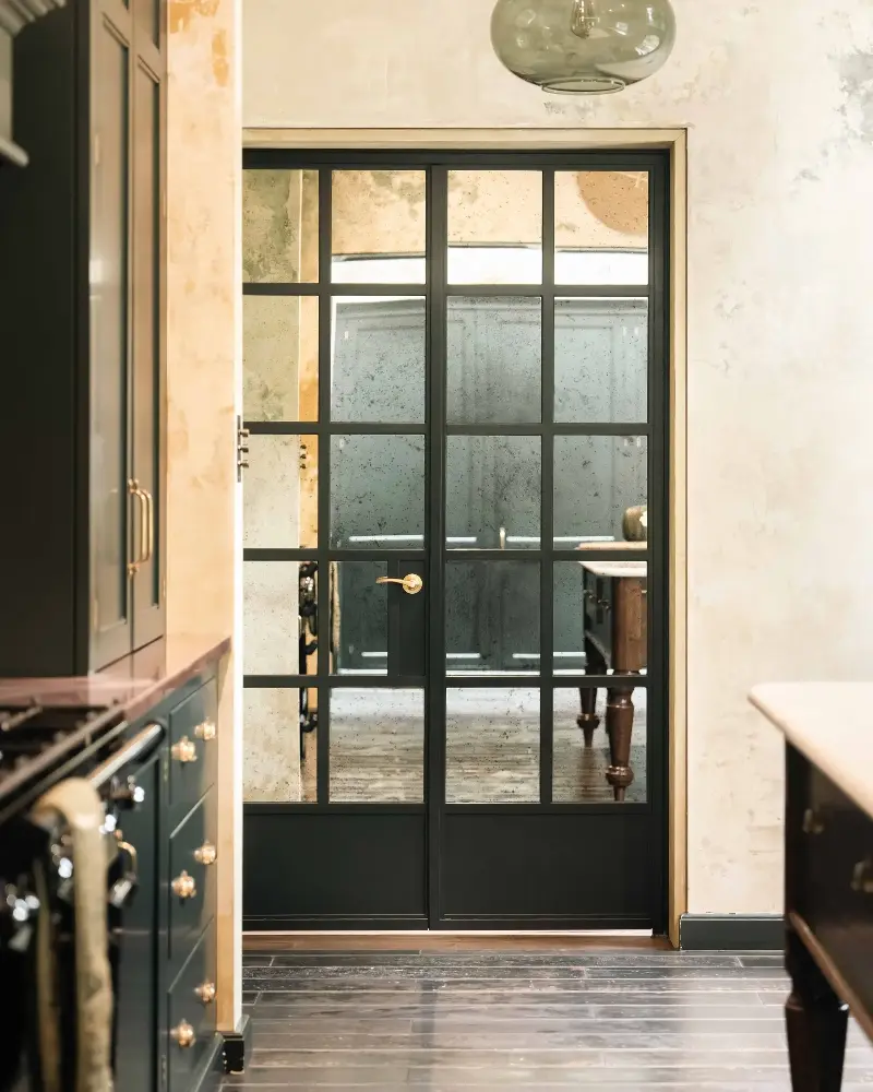 The antiqued mirror panels on the reverse of the sitting room's grand doors offer a simpler look.  (Image credit: Fabco, Studio Sam Causer)