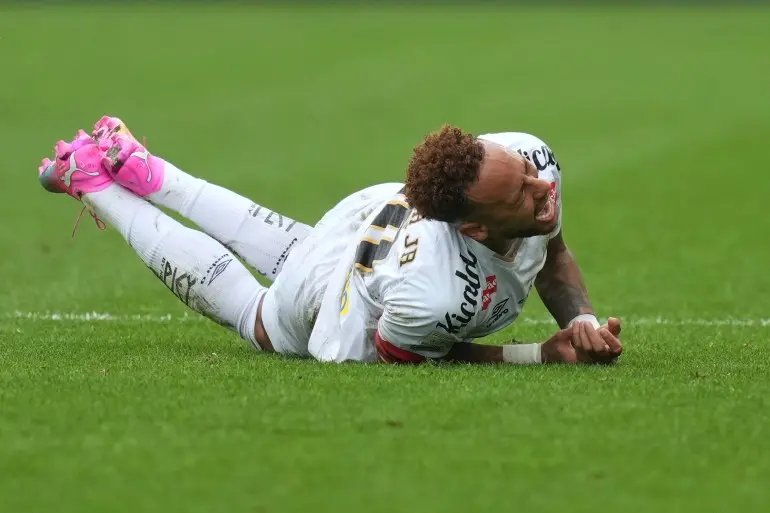 Santos' Neymar grimaces in pain after he was fouled during a Brazilian Championship soccer match against Coritiba in Sao Paulo, Sunday, May 17, 2026. (AP Photo/Andre Penner)