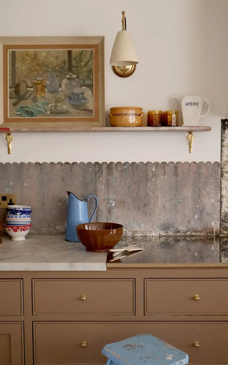 A heavy galvanised steel panel, bought at a film props auction, forms the splashback