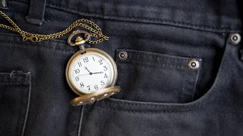 vintage pocket watch in pocket black jean