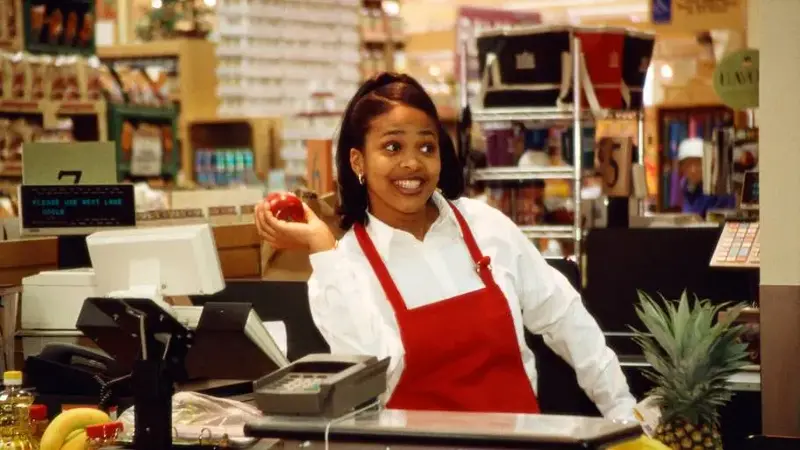 Cashier tossing apple
