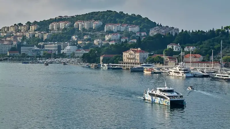 Passenger ferry in Gruz harbor with a view of Dubrovnik city.