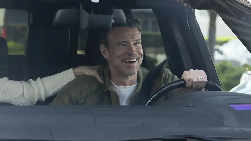 Dr. Seth McDale (Scott Foley) is happy while driving in Will Trent.