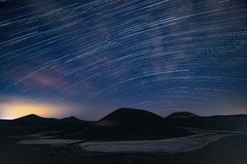 Capture the beauty of sweeping star trails over Turkey's unique terrain at night.