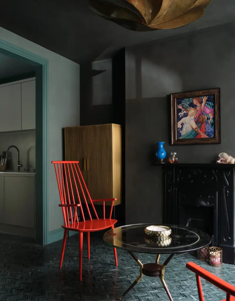 There's nothing like a colorful chair to punctuate a dark color scheme.Jake Seal. Design: Russian for Fish