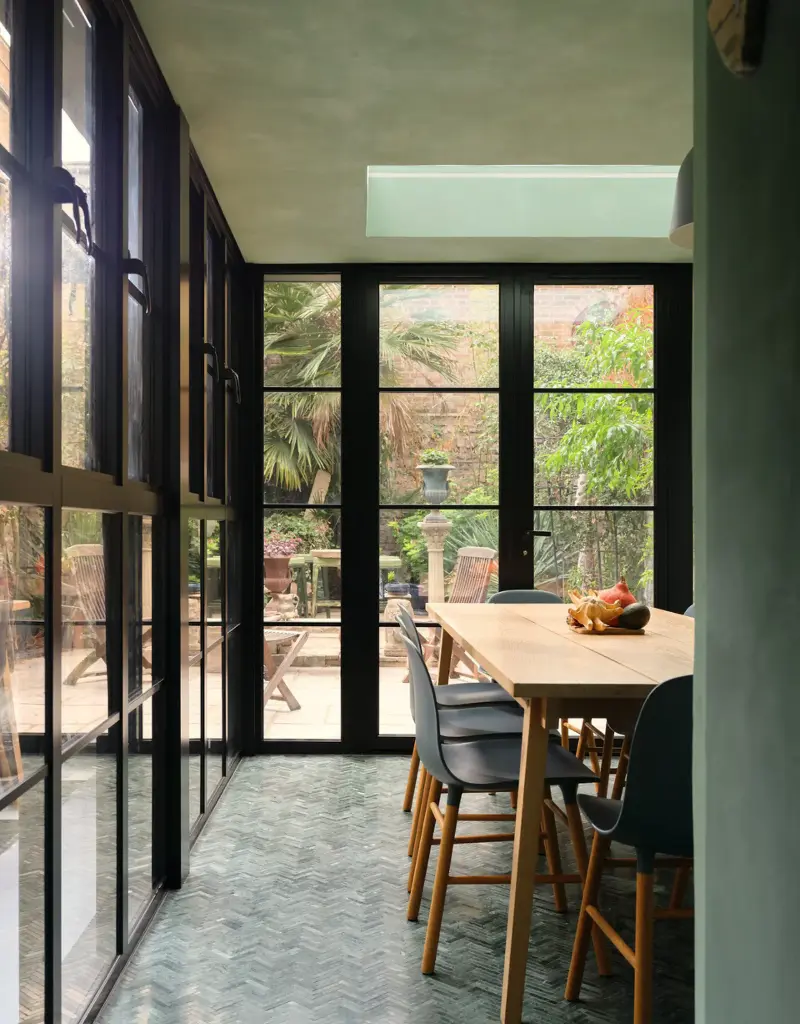 The clever use of surrounding glass windows makes the dining room feel bigger.Jake Seal. Design: Russian for Fish