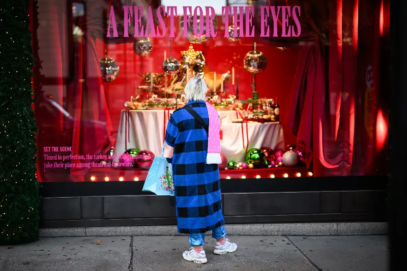 A woman stops to look at one of the Christmas window installations at Selfridges department store on Oxford Street on November 23, 2023 (Getty)