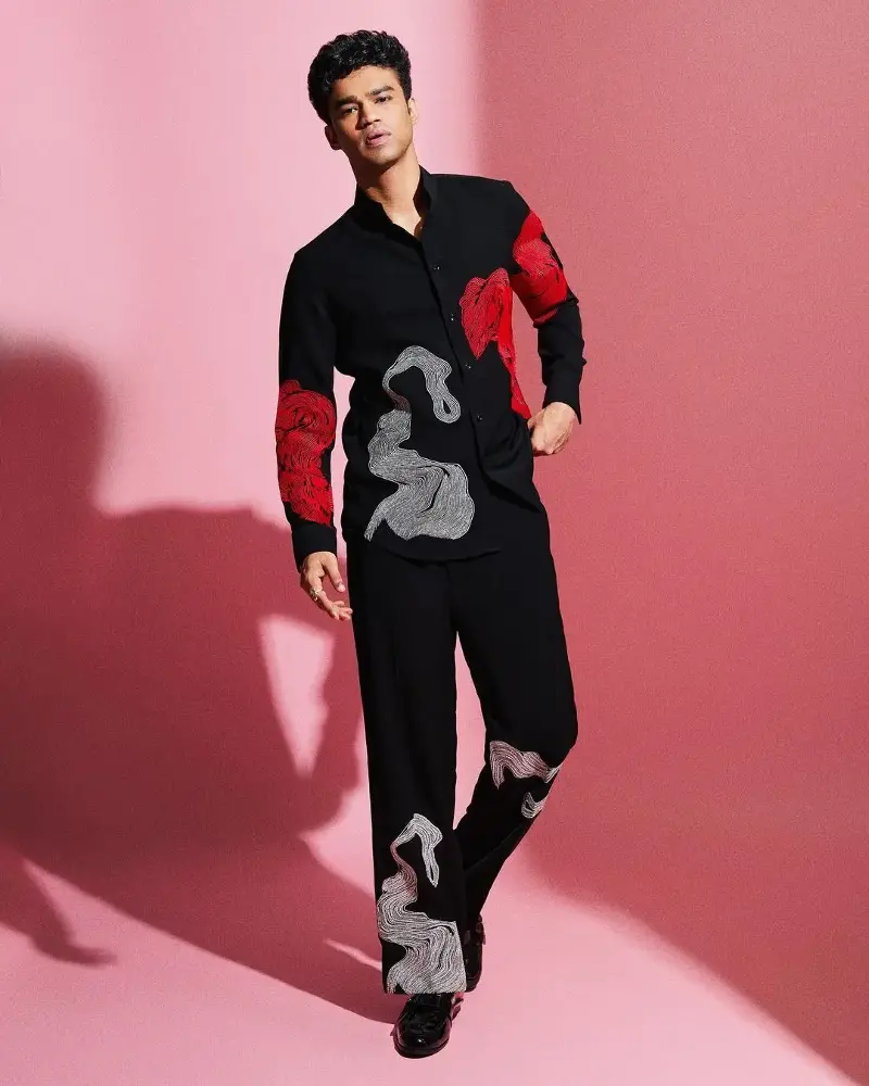 Babil Khan in a black co-ord set with abstract white and red prints