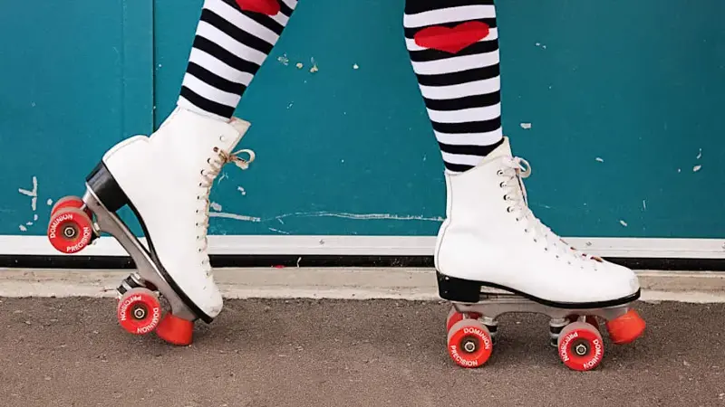 The legs of a person wearing roller skates