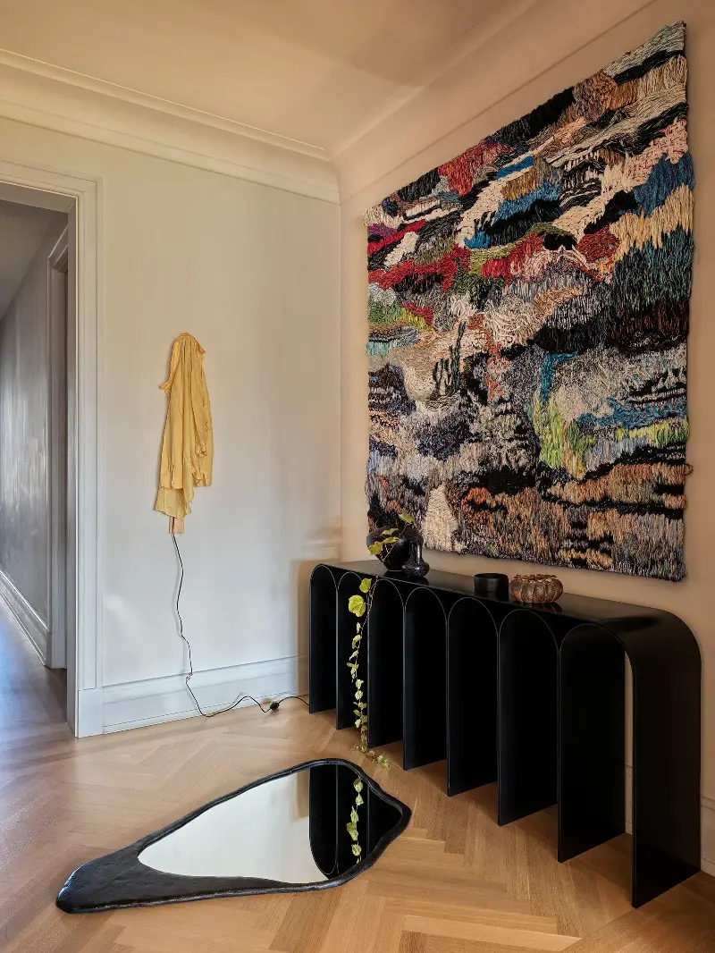Below the tapestry, a black console rises and falls in a run of arches, an echo of the building’s Beaux-Arts roots. (Image credit: Chris Mottalini. Design: Crina Arghirescu Rogard.)