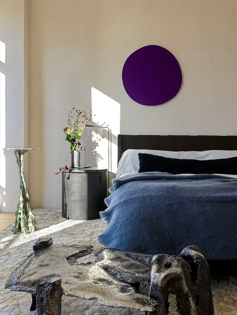 A black shearling bolster adds texture against the white linen.Chris Mottalini. Design: Crina Arghirescu Rogard.