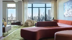 A Hockney Collage Inspired This Art-Filled Central Park Home, Where a Serpentine Sofa Bows to the View