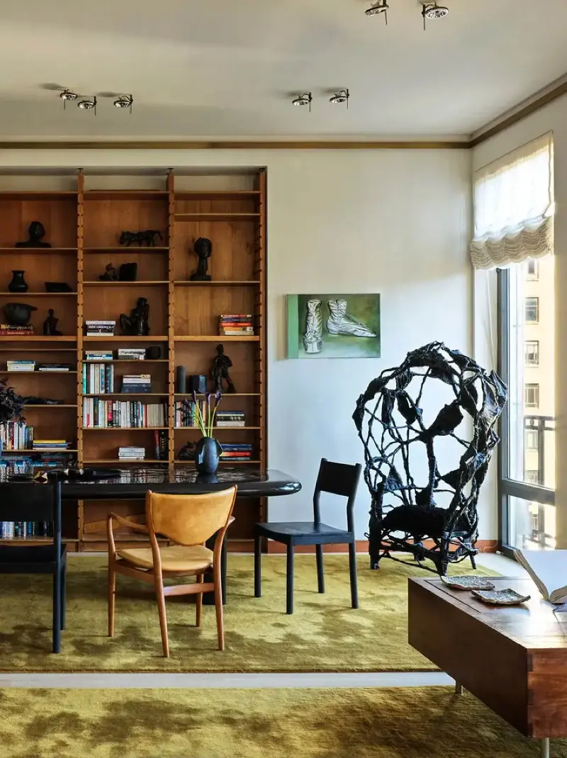 One honey-leather chair breaks the line of black ones around the table, as if someone had pulled up their favorite seat.Chris Mottalini. Design: Crina Arghirescu Rogard.