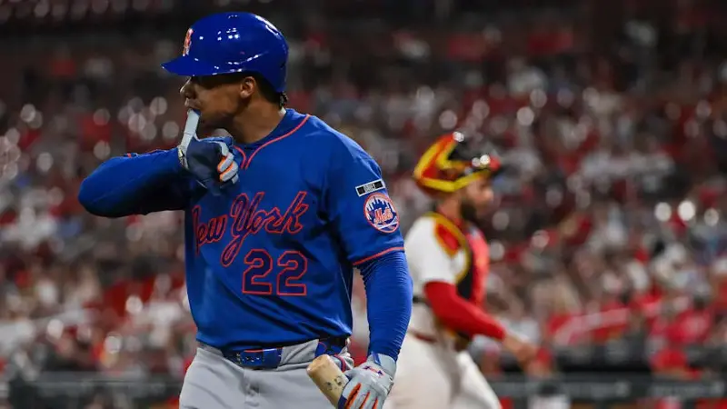 Juan Soto takes off his batting glove as he walks back to the dugout after striking out against the St. Louis Cardinals.