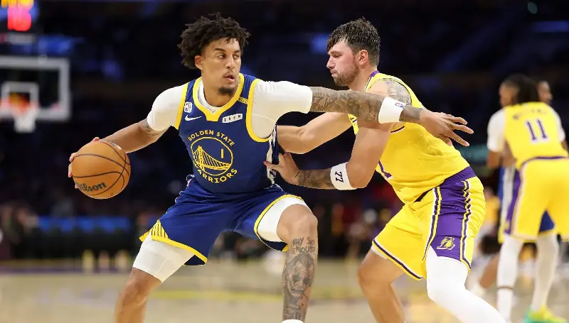 LOS ANGELES, CALIFORNIA - OCTOBER 21: Yaxel Lendeborg #1 of the Golden State Warriors dribbles into the defense. of Luka Doncic #77 of the Los Angeles Lakers during the second half of a game at Crypto.com Arena on October 21, 2026 in Los Angeles, California.  (Photo by Sean M. Haffey/Getty Images)