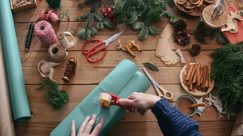 Woman's hands wrapping christmas gifts